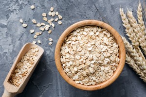 Rolled,Oats,Or,Oat,Flakes,In,Wooden,Bowl,And,Golden